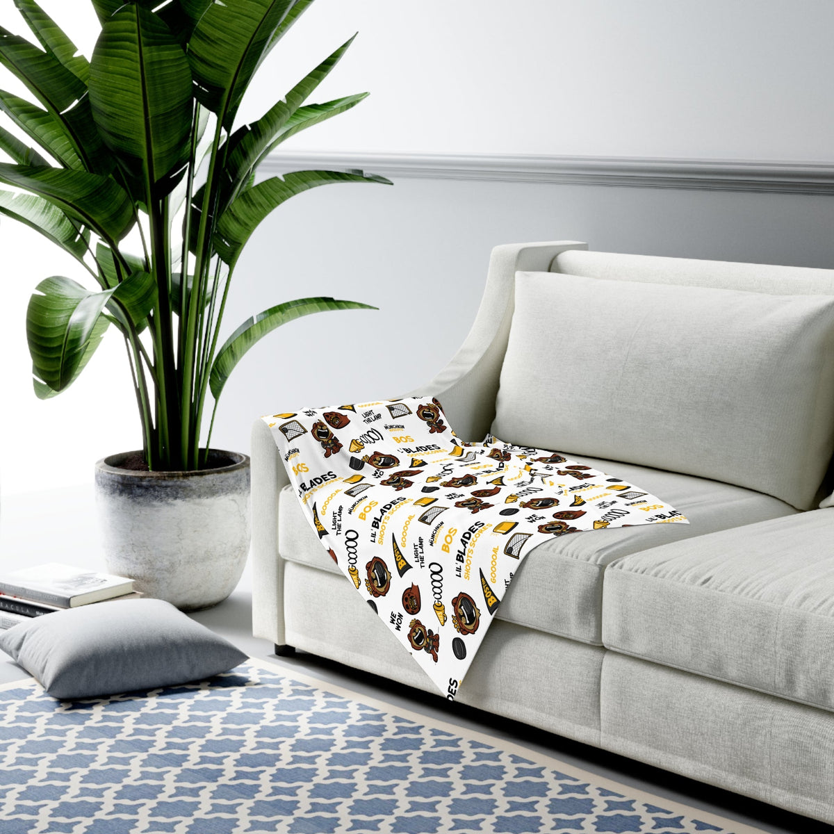 Lil' Blades hockey swaddle blanket draped over a sofa